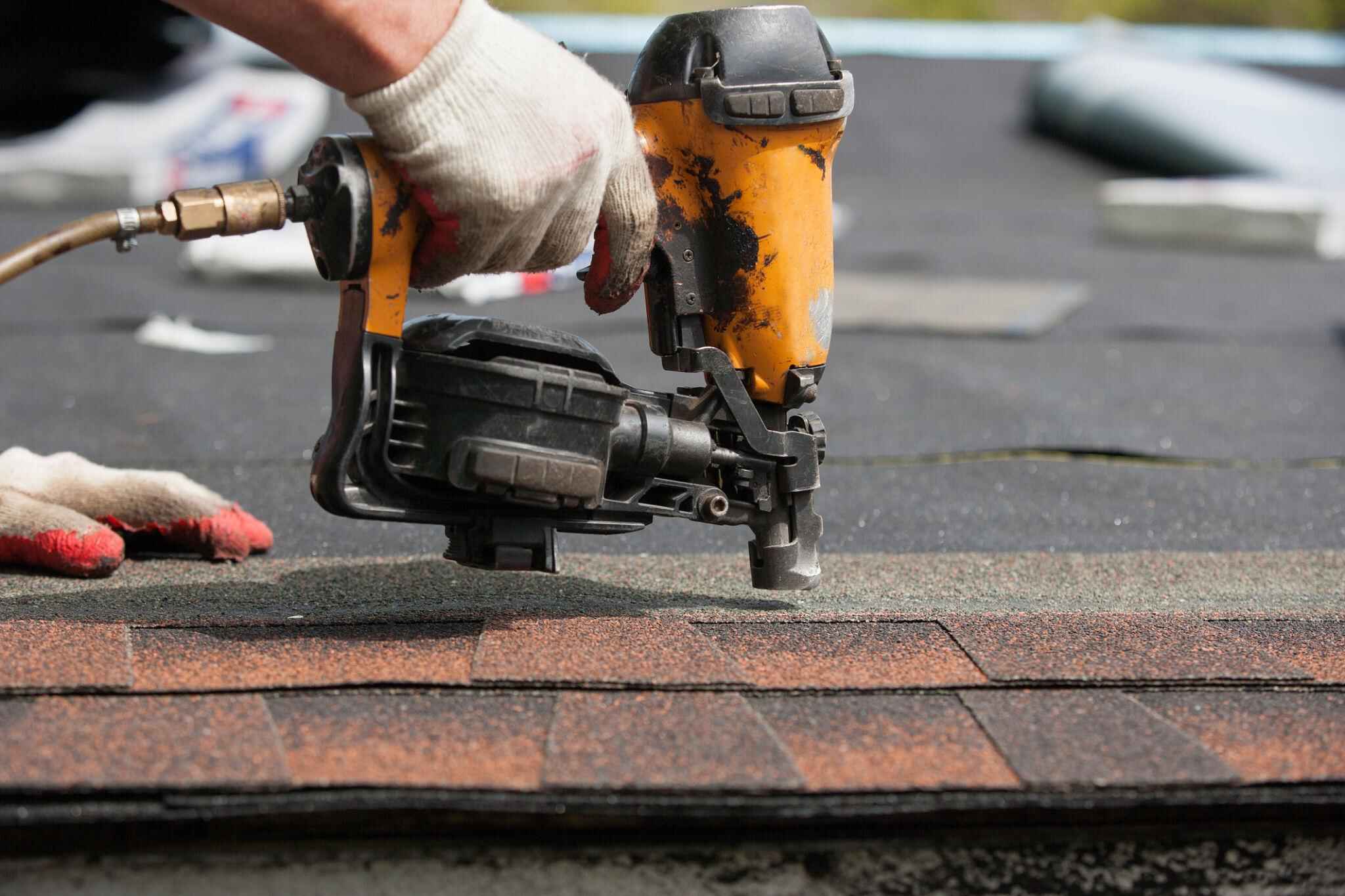 Roofing crew installing architectural shingles